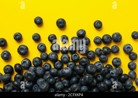 Delicious fresh blueberry on yellow background, top view Stock Photo