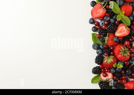 Frame made of berries on white background, space for text Stock Photo