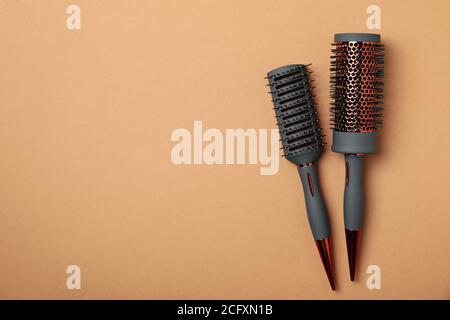 Hair brushes on brown background, space for text Stock Photo
