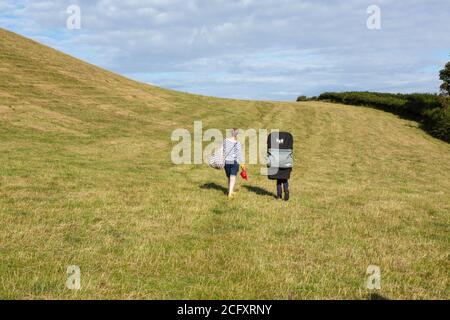 Mother and son walking in the fields near, Hope Cove, Kingsbridge, Devon, England, United Kingdom. Stock Photo