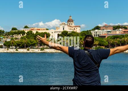 young man enthusiastic watching a coast mediterranean city Stock Photo