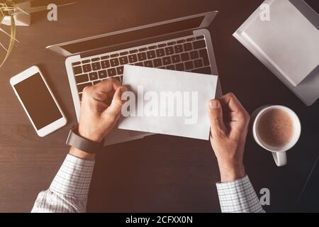 Post mail envelope mock up, top view of businessman using traditional method of correspondence Stock Photo