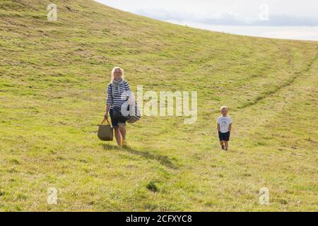 Mother and son walking in the fields near, Hope Cove, Kingsbridge, Devon, England, United Kingdom. Stock Photo