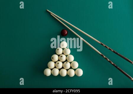 Russian billiard balls, cue, triangle, chalk on a table. Green cloth. Top view Stock Photo