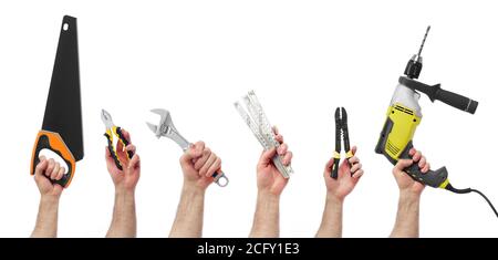 Hands raised holding different tools Stock Photo