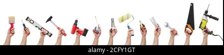 Hands raised holding different tools Stock Photo