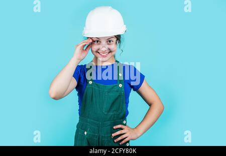 foreman teen child. kid work in helmet. little girl in a helmet. girl making repairs. teen dressed in hard hat. concept of childhood development. girl in helmet is construction worker. Stock Photo