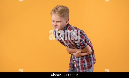 Unwell Teen Guy Suffering From Abdominal Pain Stock Photo