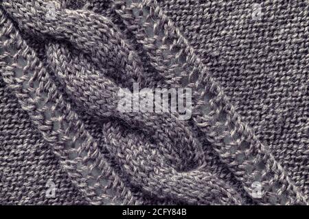 Openwork pattern knitted with needles from pink wool yarn. Stock Photo