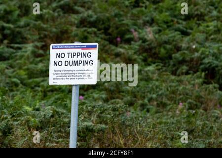 A Bradford Metropolitan Council sign in Baildon, Yorkshire, England. The sign is telling the public tipping and dumping isn't allowed. Stock Photo