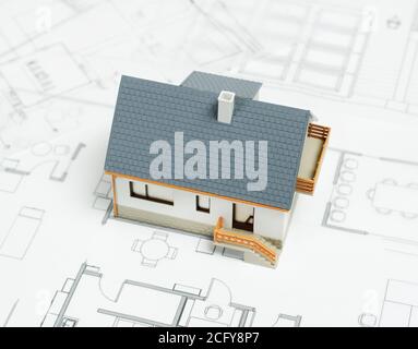Model house on top of blueprints Stock Photo