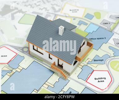 Model house on top of blueprints Stock Photo