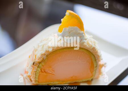 Orange cake, Orange ice cream on a plate. Stock Photo