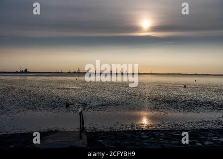 view on the wadden sea of the north sea at low tide at sunset near tossen, germany Stock Photo