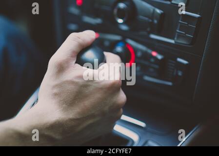 man hand shifts gearbox in car salon Stock Photo