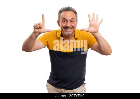 Cheerful male model smiling as making number seven counting gesture using fingers wearing casual black and yellow summer fashion concept tshirt isolat Stock Photo