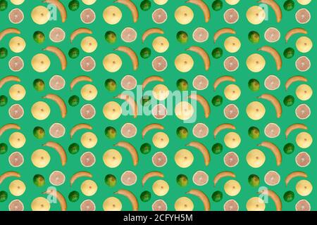 Seamless pattern tropic fruits. Banana, grapefruits and figs on green background. Healthy food concept, raw vegan. Stock Photo