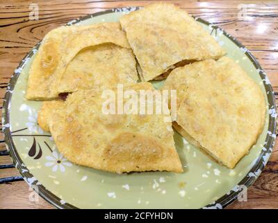 fresh sliced beef pancakes in a plate on wood table Stock Photo