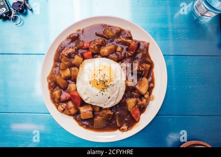 Curry Donburi ( Japanese dish consisting of a bowl of rice topped with curry ) Stock Photo