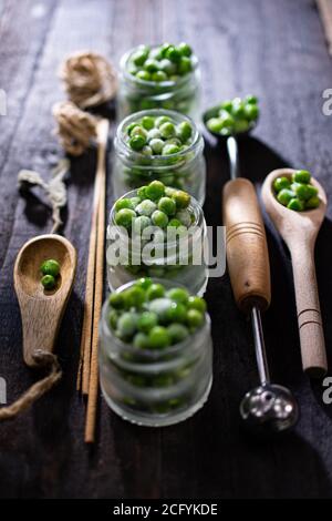 Frozen peas in jars.Healthy vegetables.Low fat food and drink.Country style. Stock Photo