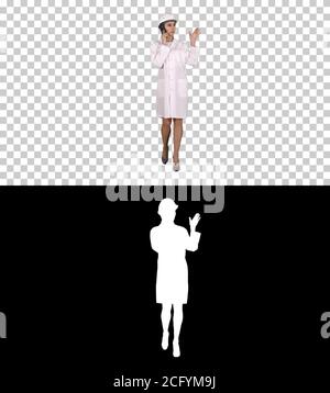 Woman engineer talking on the phone while walking, Alpha Channel Stock Photo