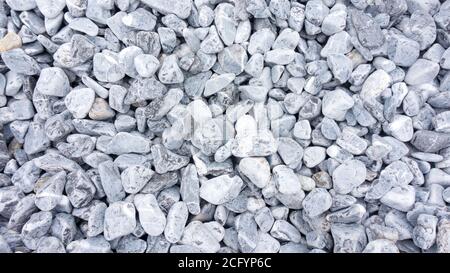Stone texture of tumbled black marble. Blue-gray background from marble stone for design templates. Marble in landscape design. Stock Photo