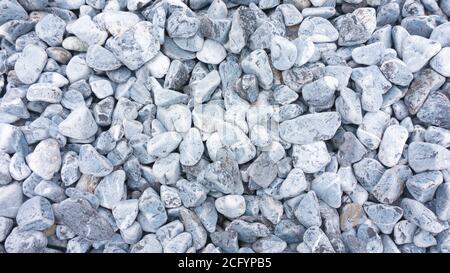 Tumbled black marmor stones for sea background. High resolution black marble stones texture. Tumbled stones of maromor in landscape design for the des Stock Photo