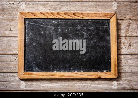 Blackboard on wooden background Stock Photo
