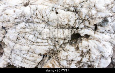 White quartz boulder background with space for text. White quartz crystals texture. Natural boulders in landscape design. Stock Photo