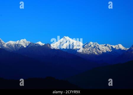 View of Mt Kanchenjunga with first rays of sunlight falling on it as seen from Hanuman top in Gantok Sikkim India Stock Photo