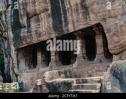 Ancient stone pillars carving inside a single red sandstone Rocky mountain, having old indian architecture. Stock Photo