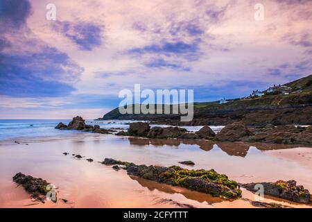 Twilight view of strata rocks and Bristol Channel taken at sunset from Croyde Bay, North Devon, England, UK. Stock Photo