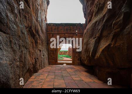 Entrance wall built in between the two big  sandstone rocks in Badami, Karnataka. Stock Photo