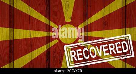 flag of North Macedonia that survived or recovered from the infections of corona virus epidemic or coronavirus. Grunge flag with stamp Recovered Stock Photo