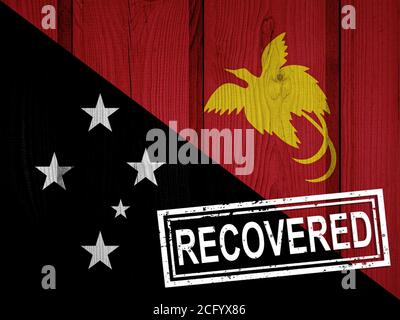 flag of Papua New Guinea that survived or recovered from the infections of corona virus epidemic or coronavirus. Grunge flag with stamp Recovered Stock Photo