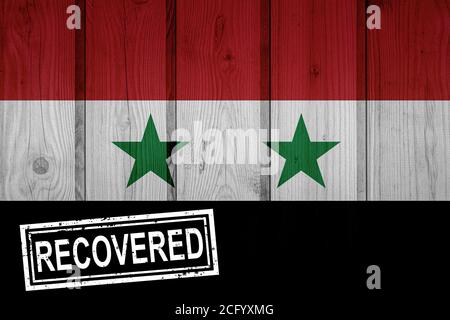 flag of Syria that survived or recovered from the infections of corona virus epidemic or coronavirus. Grunge flag with stamp Recovered Stock Photo