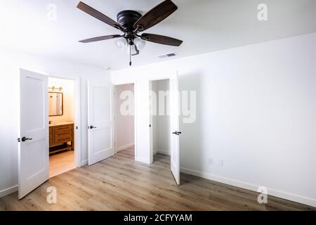 Doors in an empty bedroom leading to the livingroom, bathroom and a closet Stock Photo