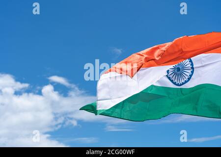 Waving India flag under blue sky background Stock Photo - Alamy