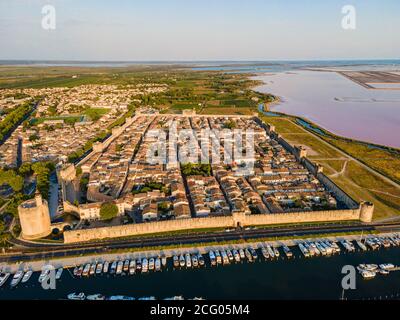 France, Gard, Petite Camargue, the medieval town of Aigues Mortes surrounded by the salt marshes (Salins du Midi) (aerial view) Stock Photo