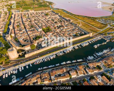 France, Gard, Petite Camargue, the medieval town of Aigues Mortes surrounded by the salt marshes (Salins du Midi) (aerial view) Stock Photo