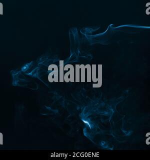 Beautiful blue smoke against dark background Stock Photo