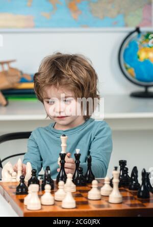 Concentrated serious boy developing chess gambit, strategy ,playing board  game to winner clever concentration and thinking child while playing chess.  Learning, tactics and analysis concept. 7292813 Stock Photo at Vecteezy