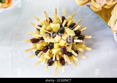 canapes from olives cheese marmalade and sausages on skewers Stock Photo
