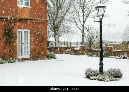 English garden of a country house in winter snow, UK Stock Photo