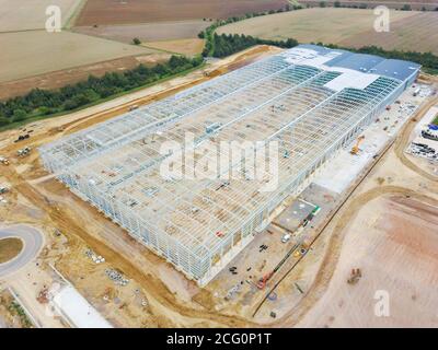 Construction is well underway in September 2020 of the Co-op food group new regional distribution centre at Symmetry Park, Biggleswade, Bedfordshire, UK The main framework for the warehouse hub of 661,000 sq ft seen here from the air. Stock Photo