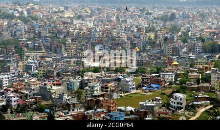 Aerial view on Kathmandu, capital of highland Nepal, located in scenic valley of Kathmandu. Town is famous for its amazing architecture and temples. Stock Photo