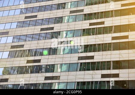 Abstract modern building background for design. Glass architecture of a modern building. The texture of the windows of the building. Stock Photo