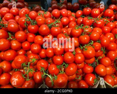View on pile of countless red ripe raw cherry tomatoes on german market Stock Photo