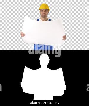 Construction worker checking blueprints on site, Alpha Channel Stock Photo