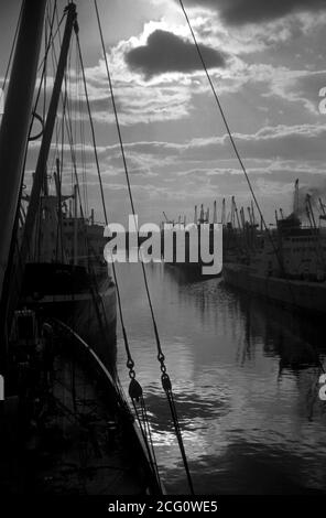 AJAXNETPHOTO. SEPT, 1963. SALFORD, MANCHESTER, ENGLAND. - SUNSET OVER THE DOCKS - VIEW FROM THE DECK OF A CARGO SHIP OF SALFORD DOCKS FILLED WITH SHIPPING. ICONIC LOCATION IN 1961 MOVIE A TASTE OF HONEY. PHOTO:JONATHAN EASTLAND/AJAX REF:M120639 091 Stock Photo